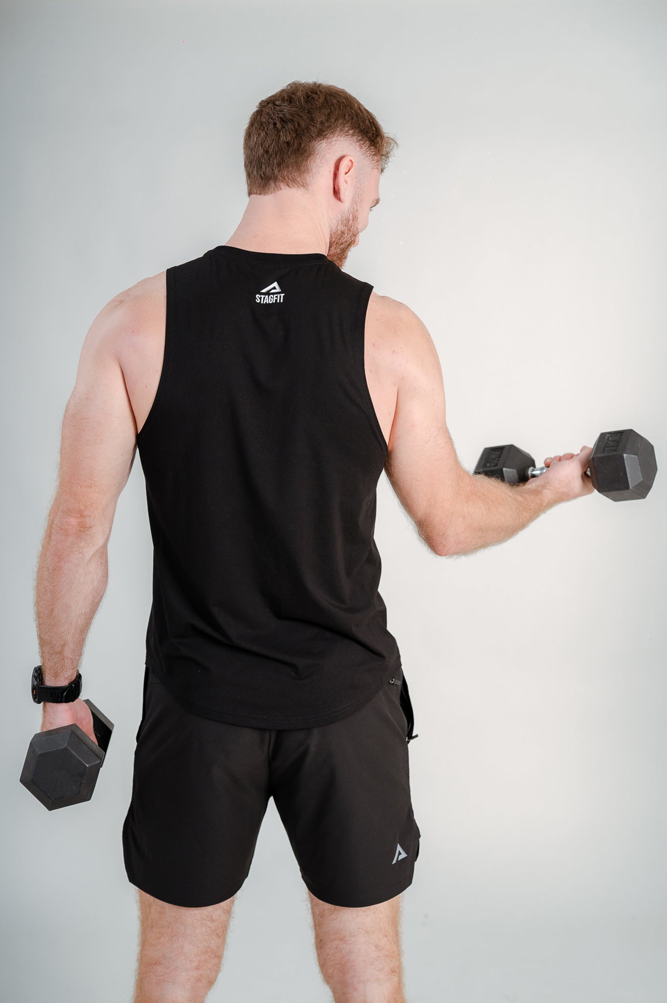StagFit Performance drop arm tank top black — back view on model.