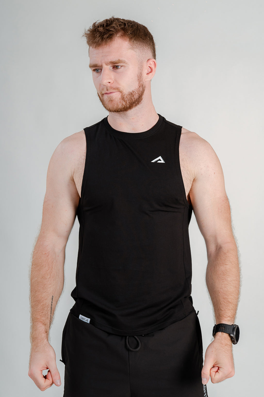 StagFit Performance drop arm tank top black — front view on model.