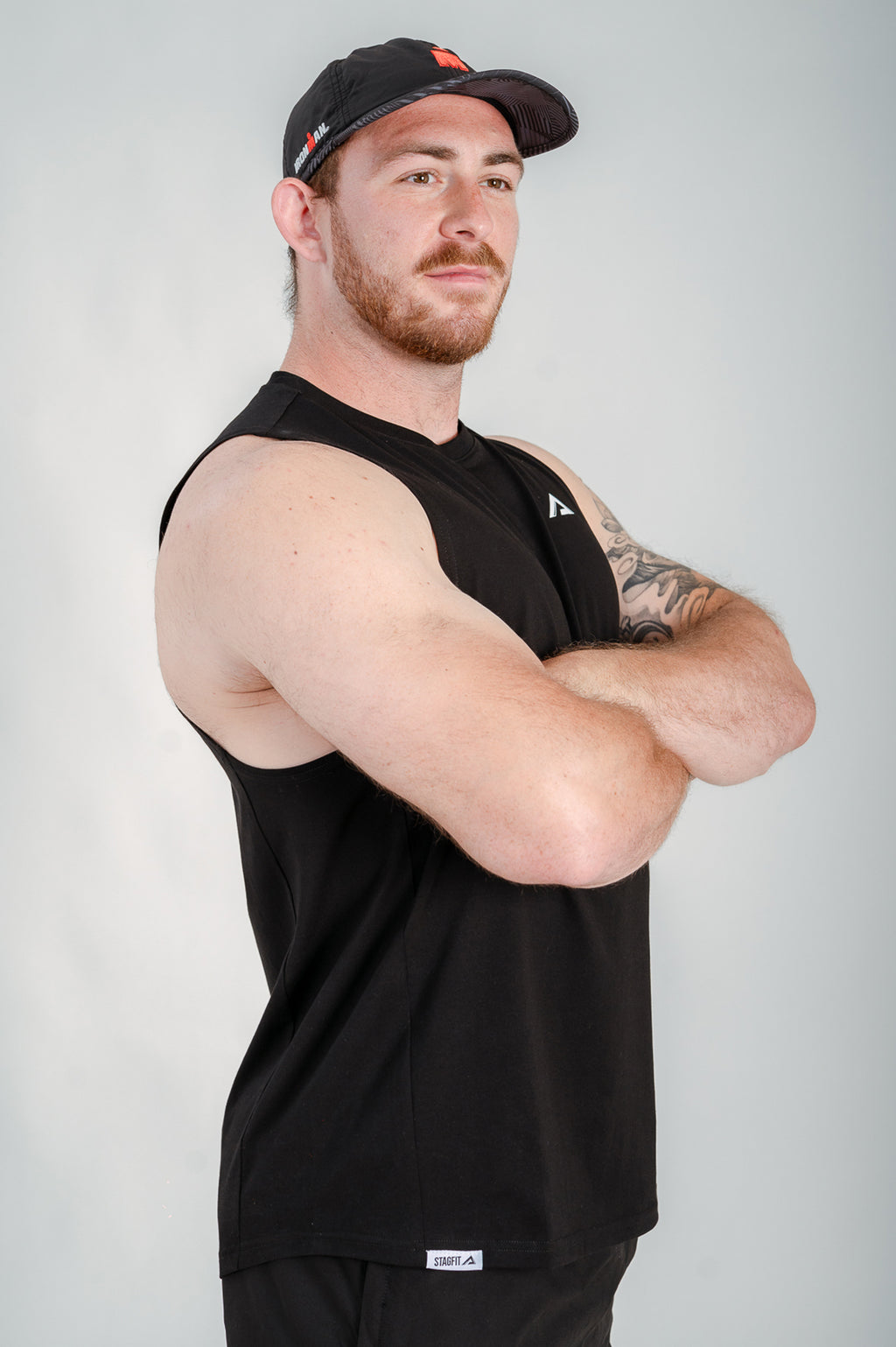 StagFit Performance drop arm tank top black — side view on model.