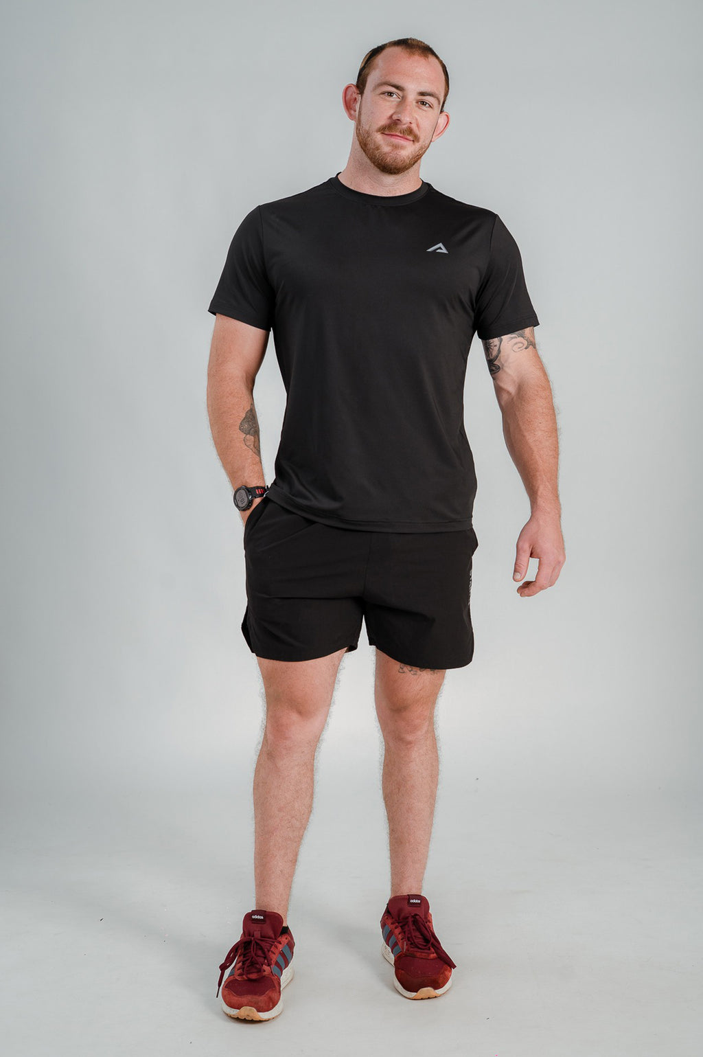 Model Standing and wearing StagFit black t-shirt.