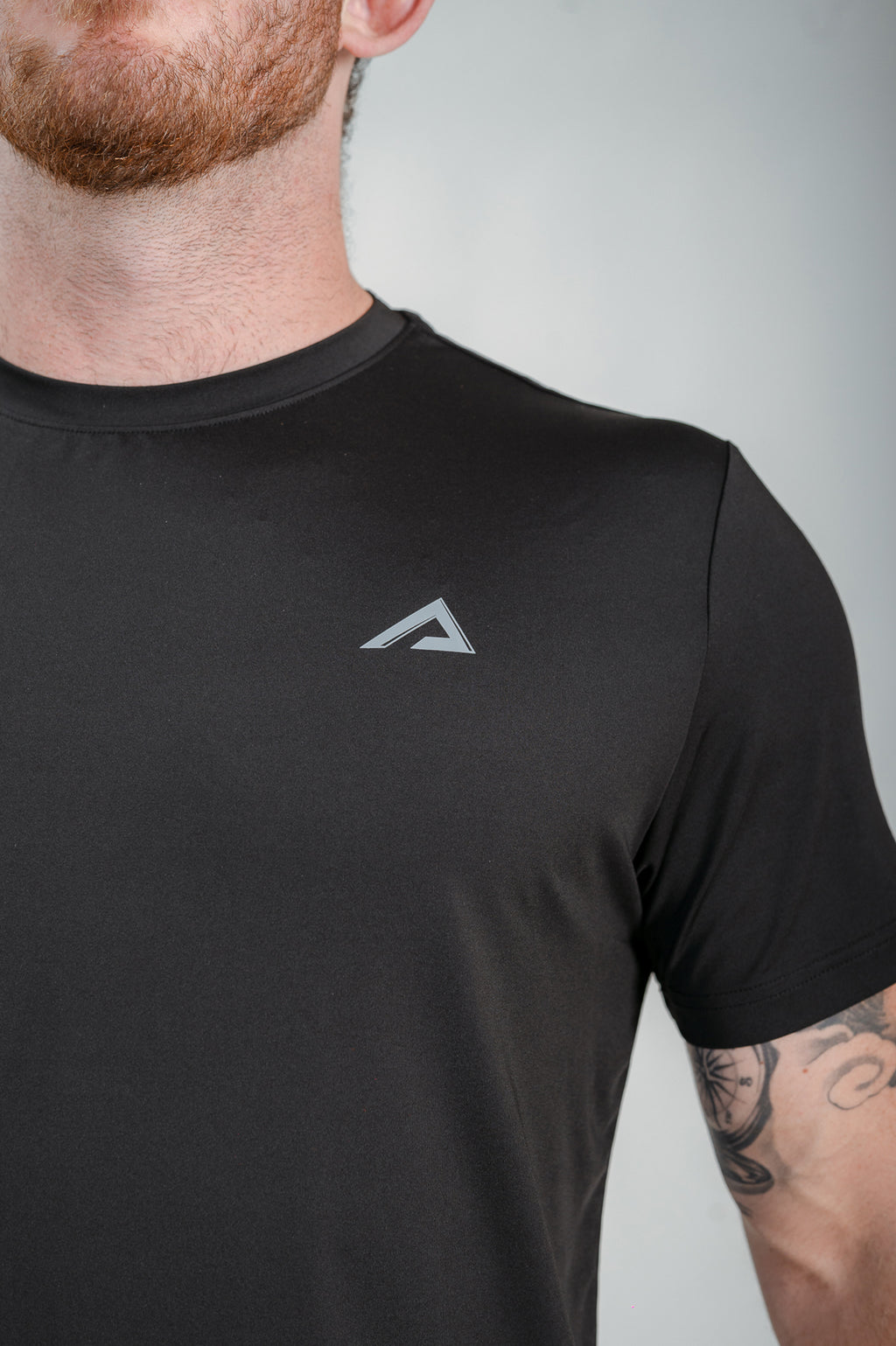 Close-up of logo, fabric and flat seams of StagFit t-shirt. 
